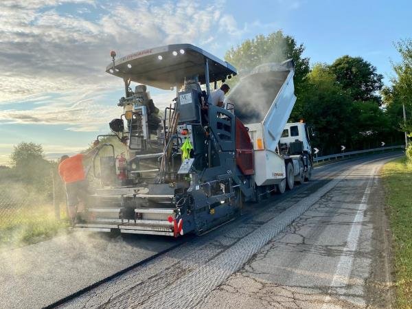 Finitrice stradale al lavoro durante una asfaltatura su strada di provincia